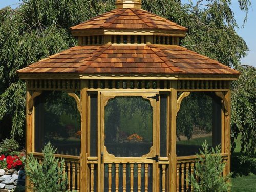 wood gazebo with screens sitting in front of large tree