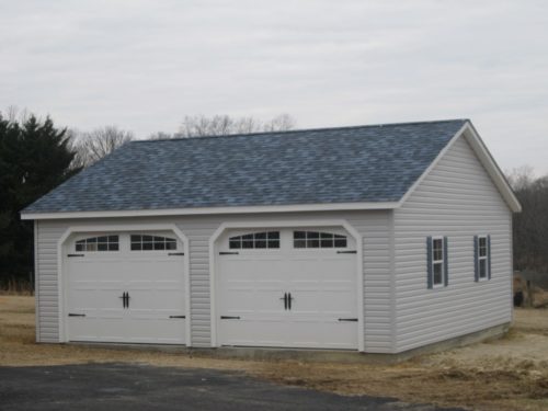 two garage garage with doors and asphalt shingles