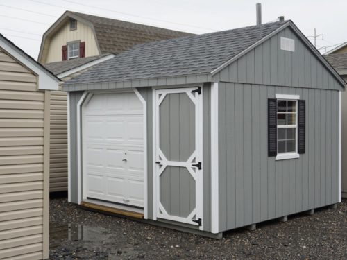 grey amish built cottage garage sitting on gravel