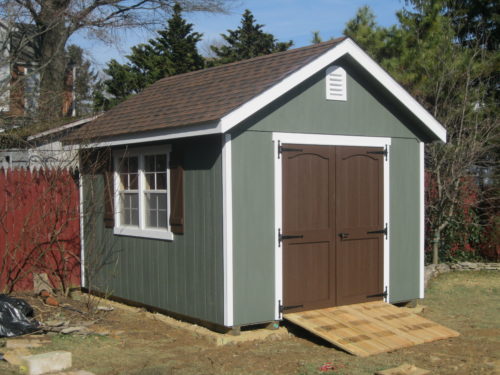classic cottage shed with brown double doors