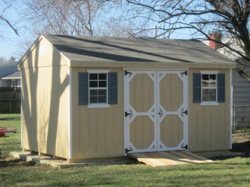 yellow cottage shed with double doors and windows