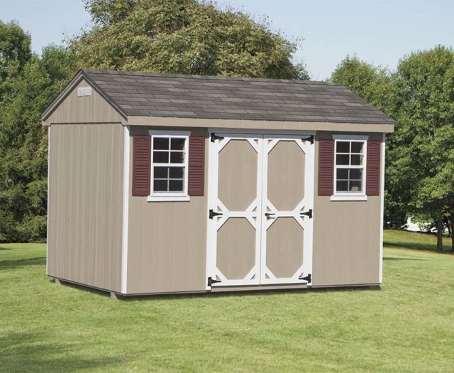 brown cottage shed sitting in backyard