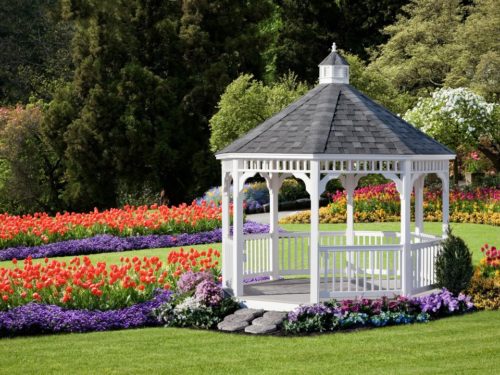 vinyl gazebo surrounded by flowers on a hill