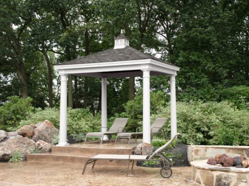 backyard vinyl pavilion sitting next to stone and bushes