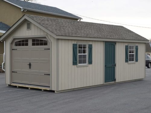 classic cottage garage on blacktop with green door