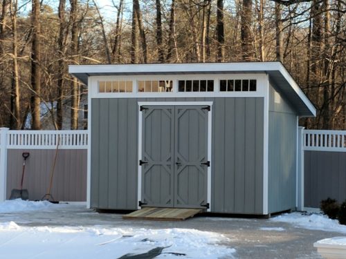 custom classic cottage shed in front of snow