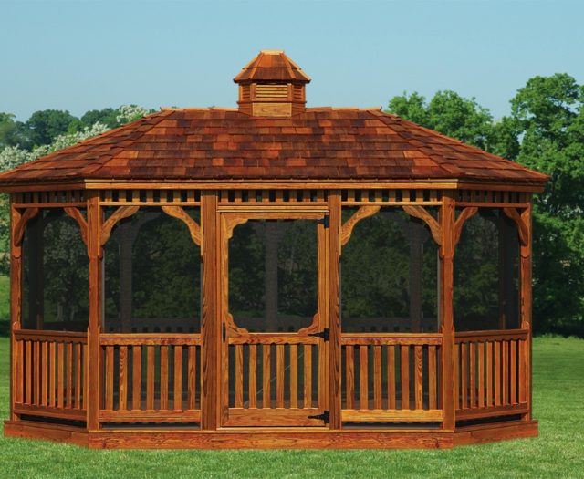 large amish built wood gazebo on grass in front of trees