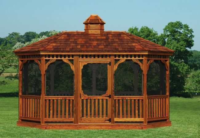 large amish built wood gazebo on grass in front of trees