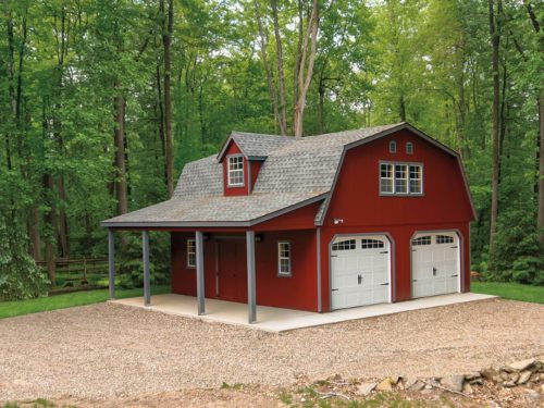 maroon two story dutch barn shed with two white garage doors