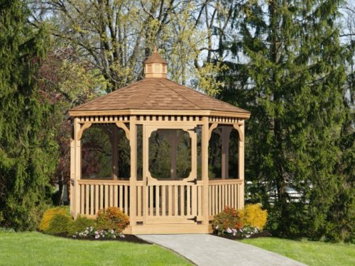 wood gazebo with stone path in front of trees