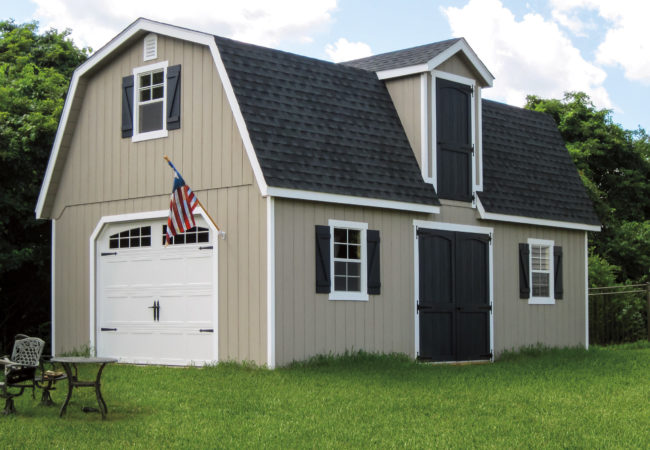 two story dutch barn shed with white garage door and american flag