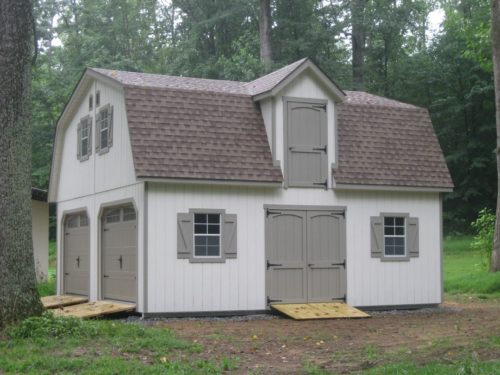 amish built two story dutch barn sitting in the woods