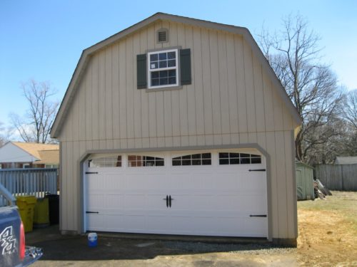 amish built two story dutch barn with white garage door
