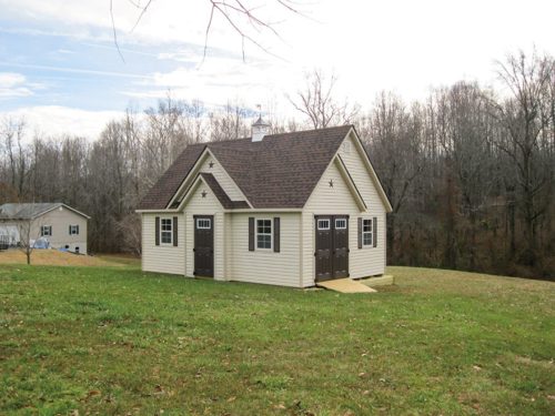 amish built alpine shed in backyard in front of trees