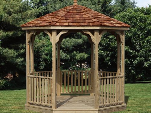 backyard wood gazebo in front of trees