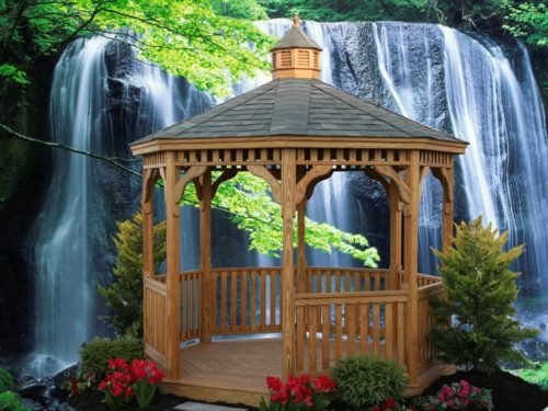 wood gazebo sitting in front of waterfall