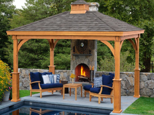 wood pavilion sitting next to pool