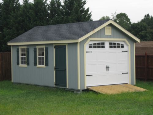 blue amish built classic cottage garage with white door
