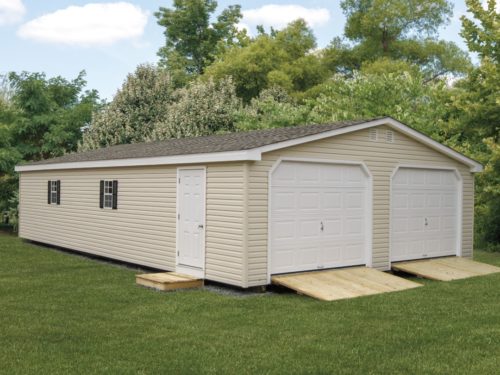 tan two car garage with two white doors and one side white door