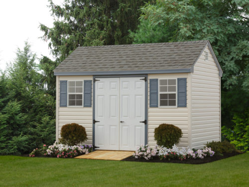 cape shed sitting in front of trees with flowers surrounding it