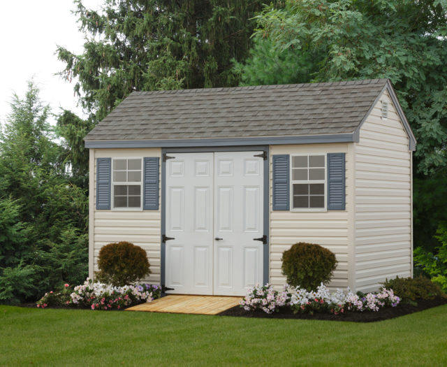 cape shed sitting in front of trees with flowers surrounding it