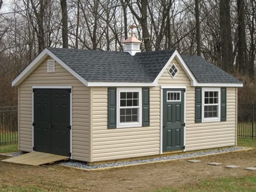 classic a frame dormer shed sitting in front of trees