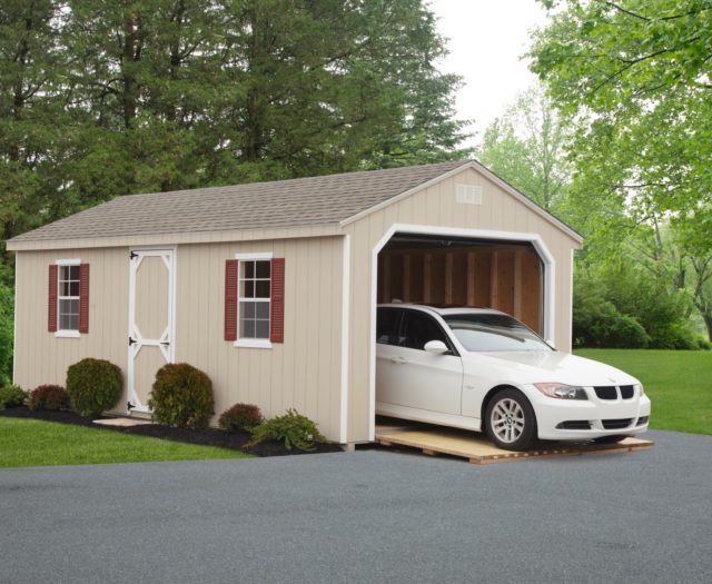 tan 7 cottage garage with white car inside