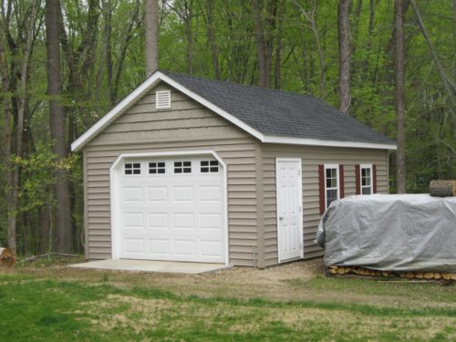 custom classic cottage shed with white garage door