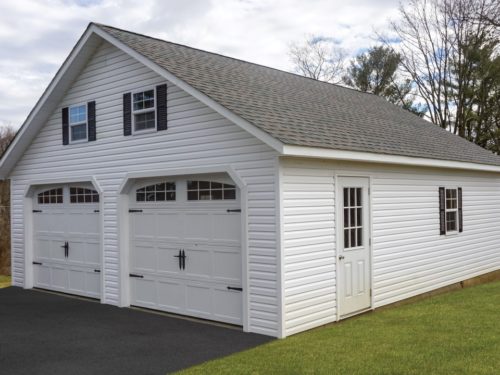 white two car garage with asphalt shingle roof