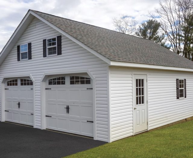 white two car garage with asphalt shingle roof