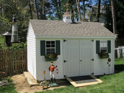 white cape shed with white doors