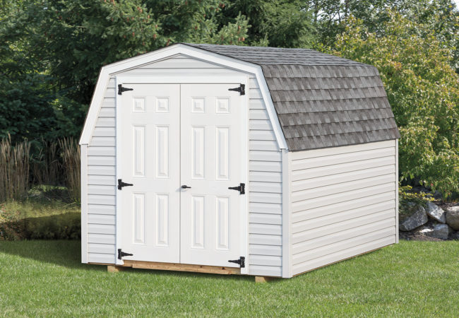 white mini barn shed sitting in backyard