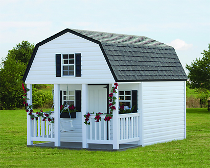 white outdoor playhouse sitting in backyard