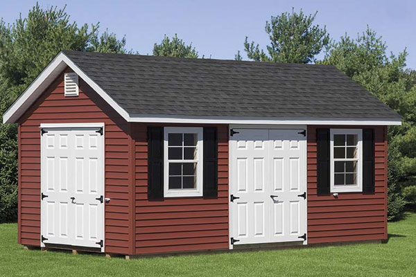 maroon classic cottage shed with white doors in maryland backyard
