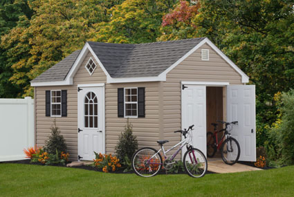 tan storage shed with open white doors and bicycles on anne arundel county property