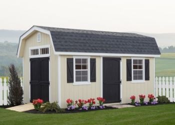 man cave shed with black doors and flowers out front